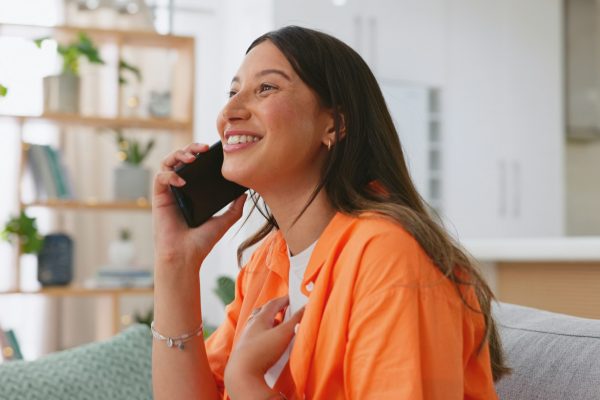 Phone call, couch and woman laughing in online conversation, talking and voip home communication. H Phone call, couch and woman laughing in online conversation, talking and voip home communication. H